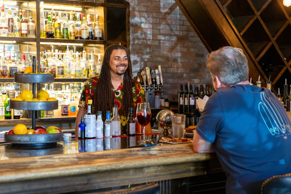 A bartender serving drinks at Caffe Boa in Tempe.
